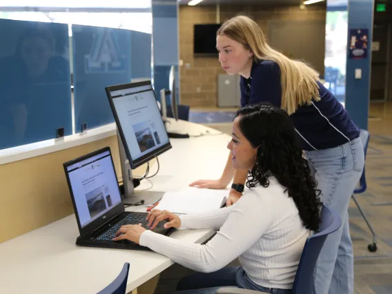 A student is being helped with their tech