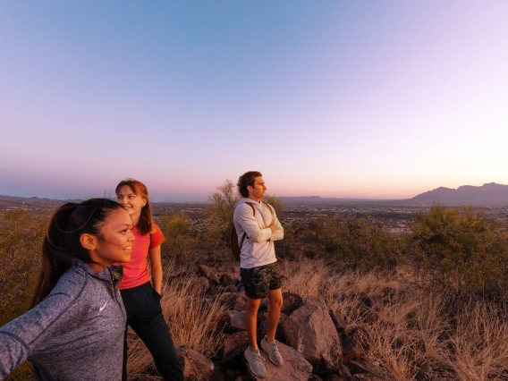 Photo of 3 UofA Student on top of Tumamoc Hill