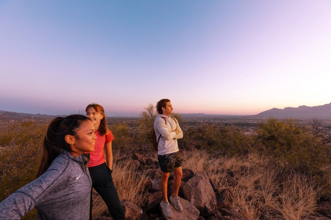 Photo of 3 UofA Student on top of Tumamoc Hill