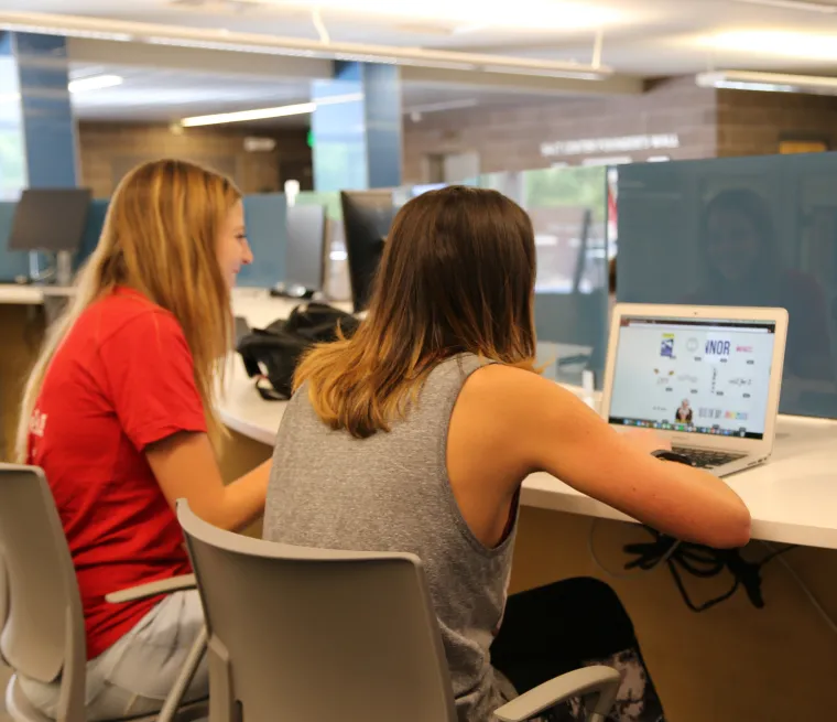 students with laptop at tech bar