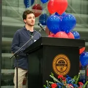 Man standing behind a podium