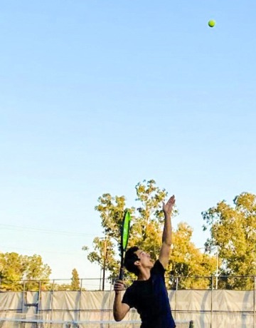 Ryan Price serving a tennis ball