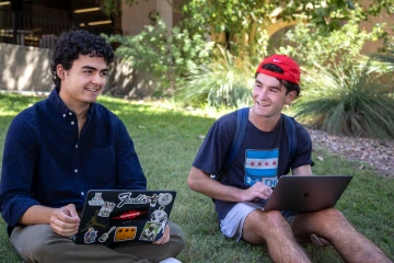 Picture of two students on grass